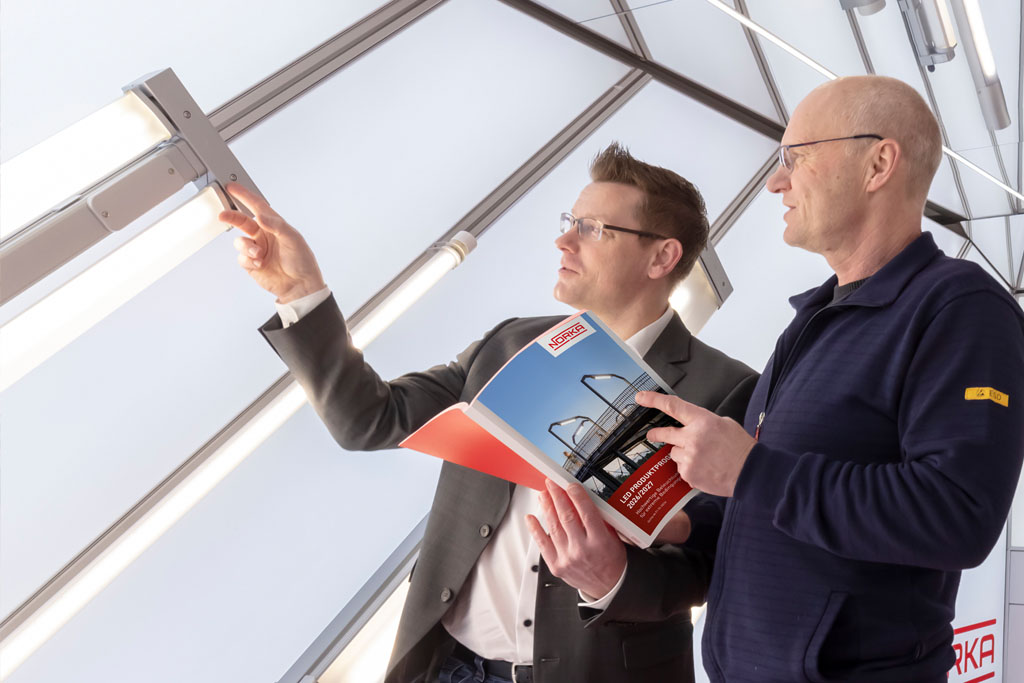 A man explains a product to an electrician